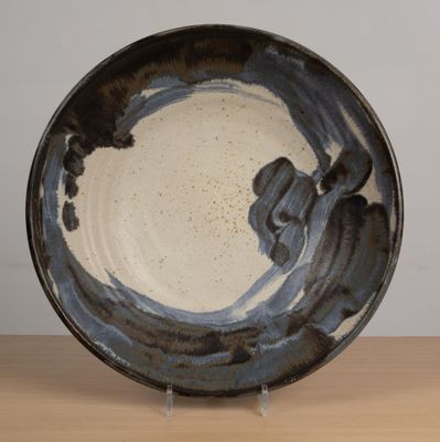 a black and white plate with a blue design on it