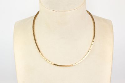 the gold necklace is on a mannequin mannequin mannequin mannequin mannequin mannequin mannequin mannequin manne