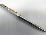 a close up of a pen sitting on top of a white surface
