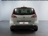 the rear of a small white car parked in a garage
