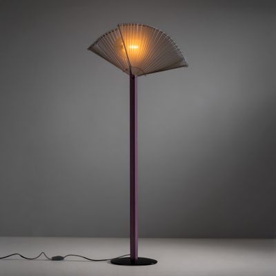 a lamp that is on a table with a fan on it