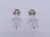 a pair of diamond earrings on a white background