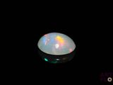 an image of a white fire opal in the dark