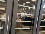 two large glass doors that are open in a building