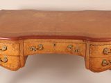 an image of a wooden desk with drawers and a leather top