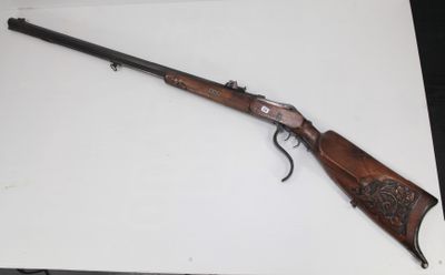 un fusil posé sur une table, sur fond blanc