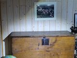 a wooden chest with a globe on top of it in a room