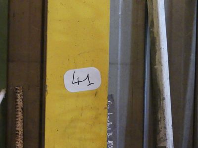 a sticker that says 14 on the side of a yellow door