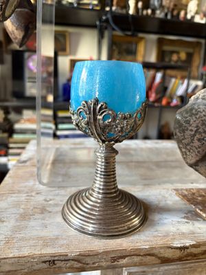 a blue candle that is sitting on a wooden table