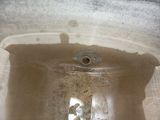 a dirty sink in a dirty bathroom with a faucet in it