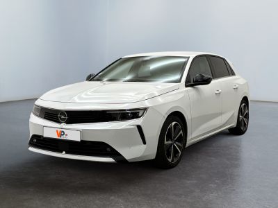 a white car is parked in a room with a black floor