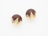 a pair of gold and wood stud earrings with diamonds
