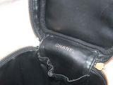 a black purse that is open on a white surface