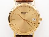 a close up of a gold wrist watch on a white surface