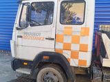 a truck that is parked in front of a blue wall
