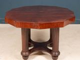 an octagonal table with a wooden top on a white floor