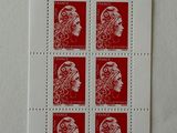 four red and white stamps with a woman ' s face on them