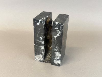 two black marble bookends with a statue of a woman in the middle