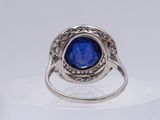 a close up of a ring with a blue stone in it