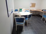 a table and chairs in a room with tile flooring