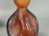 a brown glass vase with a design on it