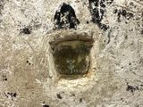 a hole in the wall that has a picture of a man on it