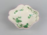 an image of a white bowl with green flowers on it