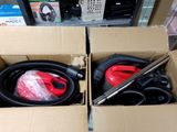 two boxes with vacuums and a hose in them