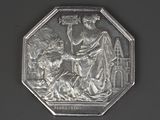 une pièce d'argent à l'effigie d'une femme et d'un enfant