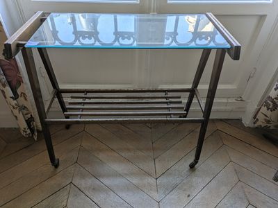 a glass table with a metal frame on it