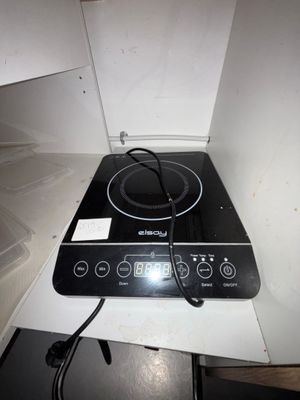 a black stove top with a black burner on it