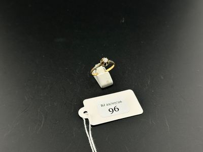 a close up of a tag on a table with a ring on it