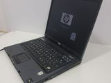 laptop computer sitting on top of a white table next to a mouse