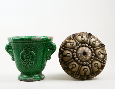 a green vase next to a green vase on a white surface