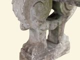 a close up of a stone bench with a stone head on it