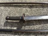 two swords that are laying on the ground