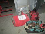 Plusieurs bagages sont posés par terre à côté d'un tabouret.