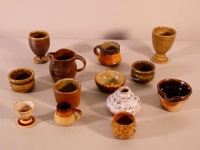 many different types of cups and saucers on the table
