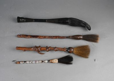 three different types of brooms and a brush on a table