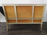 a close up of a couch with a wooden frame on it