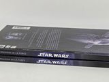 two star wars books are stacked on top of each other