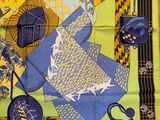 a yellow and blue scarf with a picture of a teapot and teapots on it