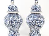 pair of blue and white vases with lids on a white background