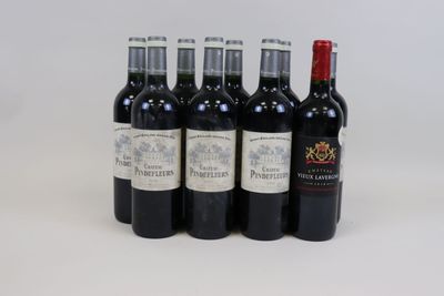 six bottles of wine are lined up in a row on a white surface