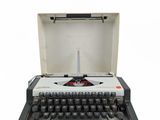 an old typewriter with a white case and black keys