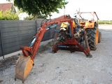 a tractor that is parked next to a fence