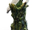 a white swan that is sitting on top of a tree stump