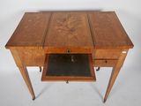 a small wooden desk with a drawer underneath it
