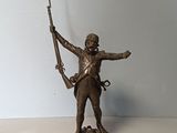 statue en bronze représentant un homme tenant un fusil et un fusil