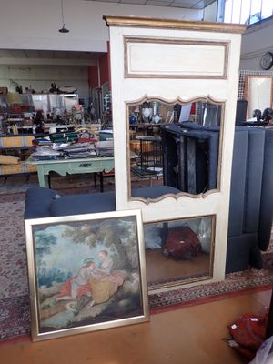two framed pictures on the floor in a room